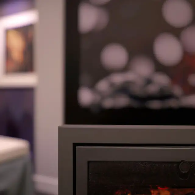Living room fireplace trends, Newcastle Soft-focus view of a modern fireplace in a living room with warm lights behind