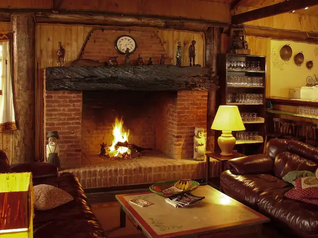 Traditional brick fireplace with a log fire in a cosy living room